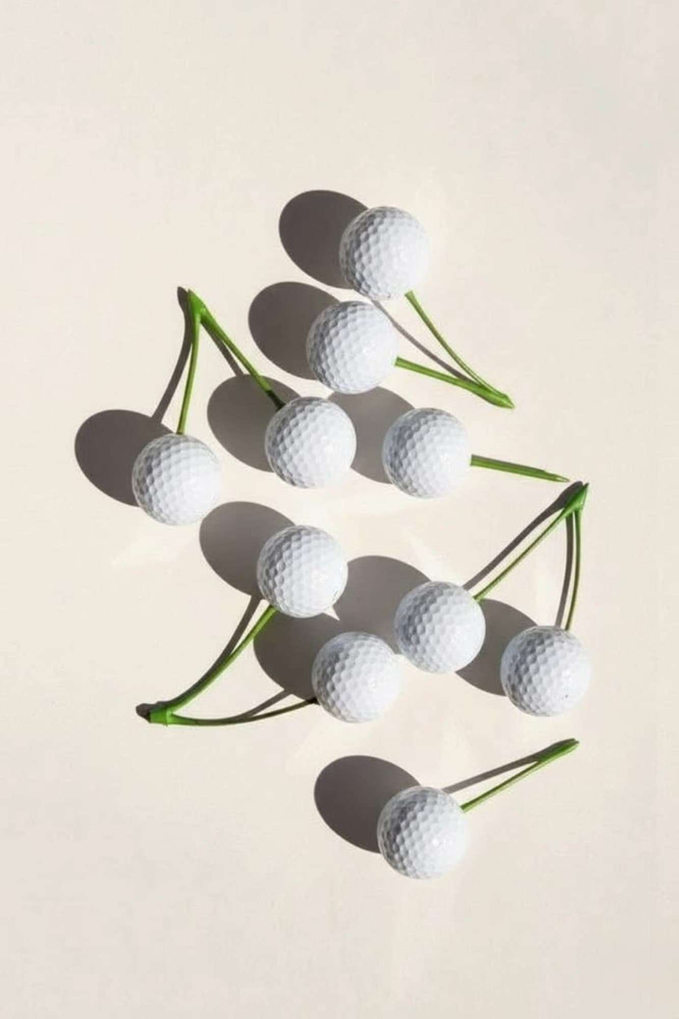 Golf balls resting on green tees